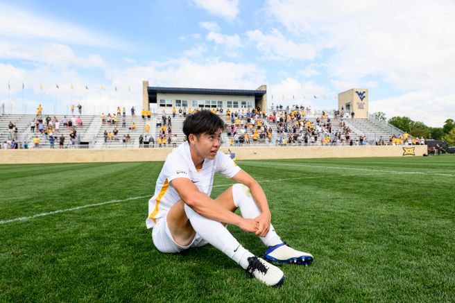 Yutaro Tsukada sits on the pitch following the Mountaineers win over Portland.