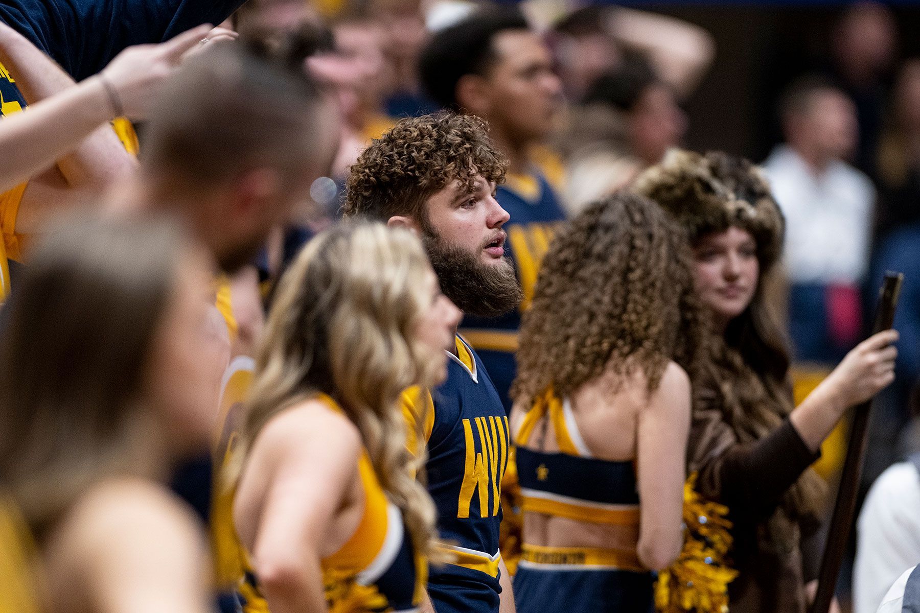 Mikel Hager in the crowd as a cheerleader at a WVU basketball game