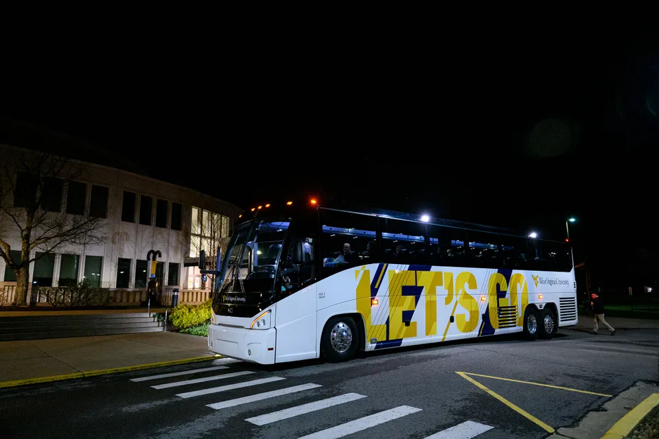 bus in front of the creative arts center in the dark