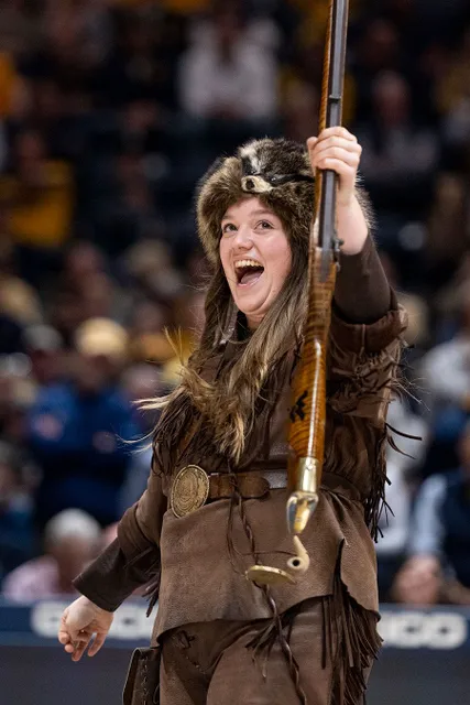 Mary Roush cheers as the Mountaineer mascot