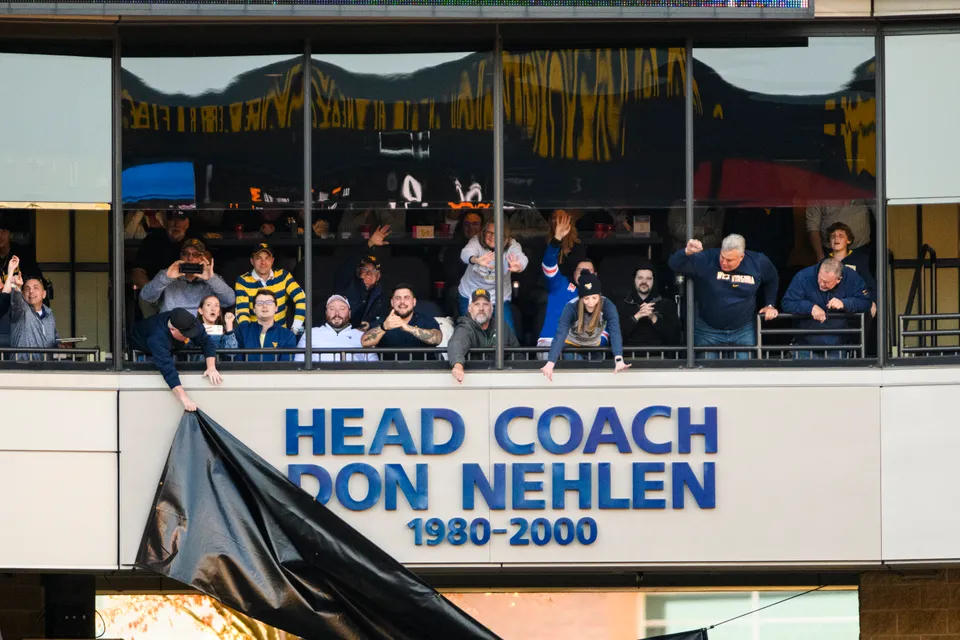 A black tarp is removed to reveal Don Nehlen's name on Diversified Energy Terrace as he's honored at Milan Puskar Stadium.