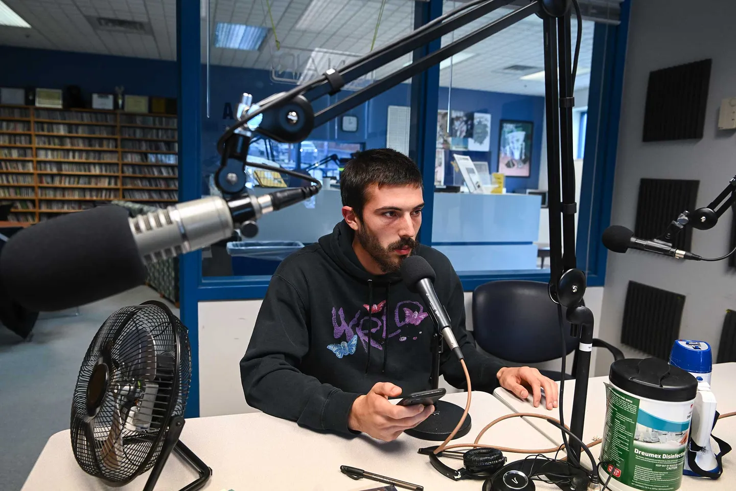 Toby Sherman reads an on-air update at the studios of U92 The Moose, the student-run radio station at WVU.