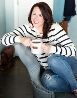 person sits on chair holding mug