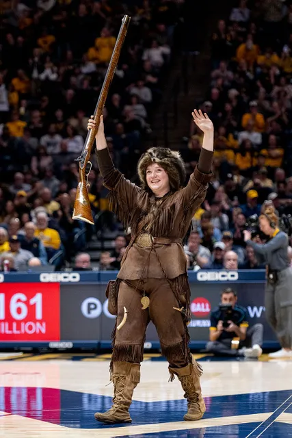 Mary Roush greets the crowd as the Mountaineer mascot