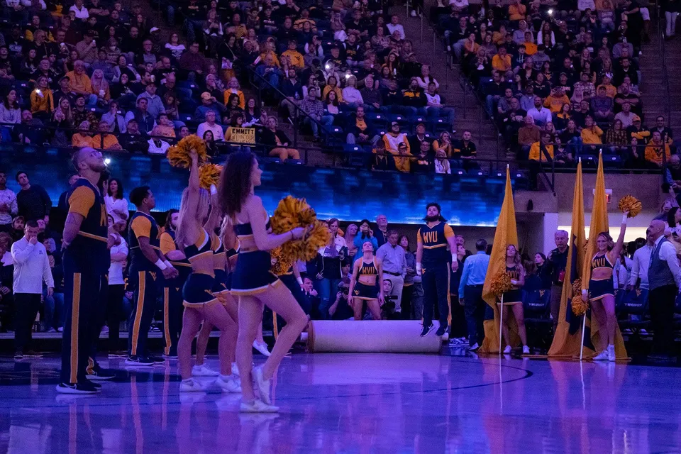Mikel Hager cheers with the WVU Cheerleaders